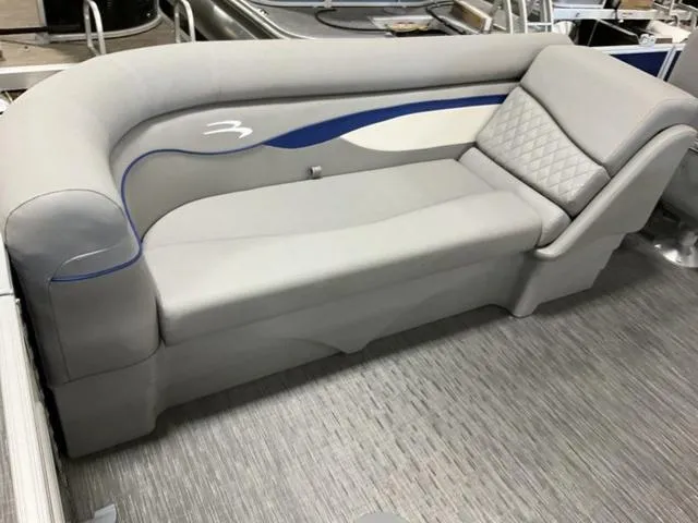 Slide: The Image of 2023 Bennington 22 SSR boat interior with gray cushioned seating and blue accents. - 4