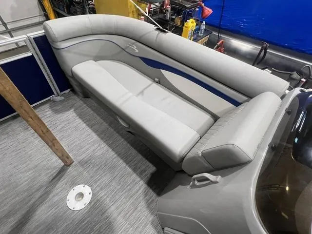 Slide: The Image of 2023 Bennington 22 SSR boat interior with gray seating and blue accents. - 7