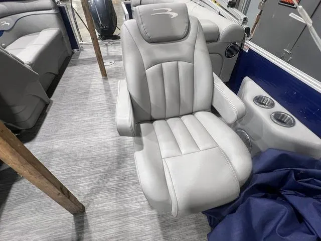 Slide: The Image of 2023 Bennington 22 SSR boat interior with plush gray captain's chair and cup holders. - 9