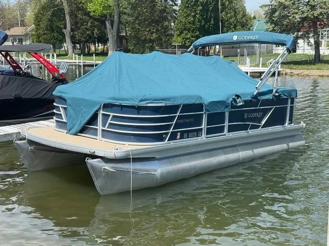 Slide: The Image of 2021 Godfrey Pontoons SW 2086 C covered, docked on a calm lake. - 12