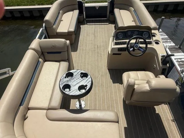 Slide: The Image of 2021 Godfrey Pontoons SW 2086 C interior with beige seating and steering console. - 3