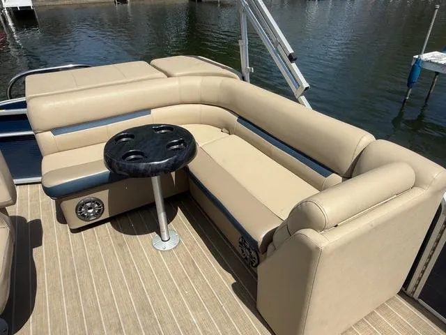 Slide: The Image of 2021 Godfrey Pontoons SW 2086 C interior with beige seating and round table on water. - 7