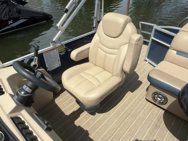 Slide: The Image of Captain's chair on 2021 Godfrey Pontoons SW 2086 C, beige upholstery, steering wheel visible. - 8
