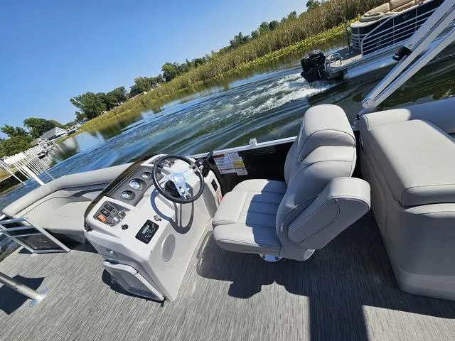 Slide: The Image of 2023 Bennington 24 SSR pontoon boat interior with steering console and comfortable seating. - 4