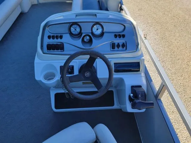 Slide: The Image of 2008 JC MFG Neptune 23 boat dashboard with steering wheel and control panel. - 10