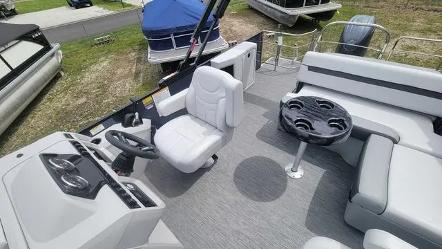 Slide: The Image of 2024 Godfrey Pontoons Sweetwater 2286 SFL interior with helm, seating, and table. - 5