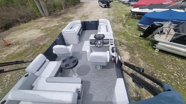 Slide: The Image of 2024 Godfrey Pontoons Sweetwater 2286 SFL, spacious interior with seating and helm, docked outdoors. - 8