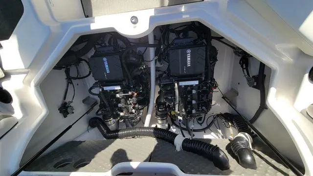Slide: The Image of 2022 Yamaha AR210 boat engine compartment with dual engines and wiring. - 14