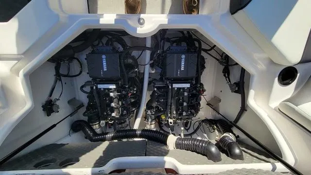Slide: The Image of 2022 Yamaha AR210 boat engine compartment with dual engines and wiring. - 15