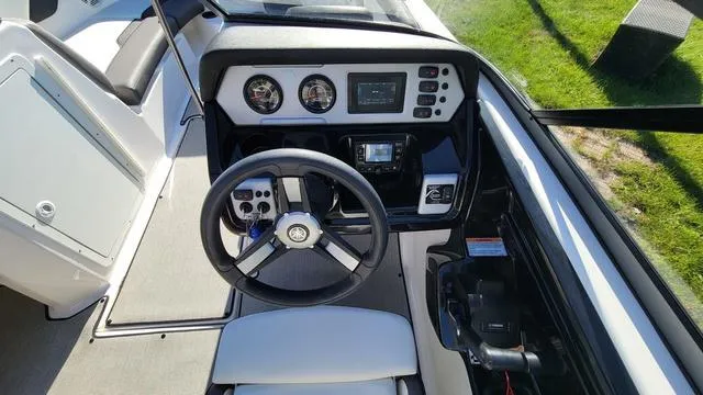 Slide: The Image of 2022 Yamaha AR210 boat dashboard with steering wheel and control panel. - 6