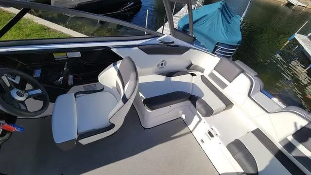 Slide: The Image of 2022 Yamaha AR210 boat interior with sleek seating and modern dashboard design. - 7