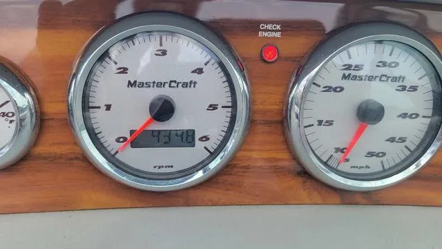 Slide: The Image of Dashboard of 2004 MasterCraft MariStar 210 with gauges and check engine light. - 8