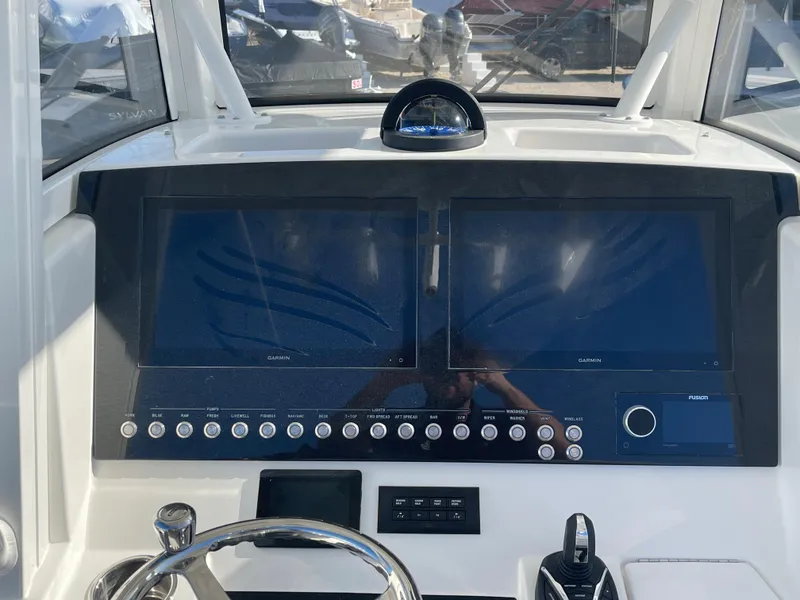 Slide: The Image of 2022 Regulator 28 boat dashboard with dual screens and control panel. - 14