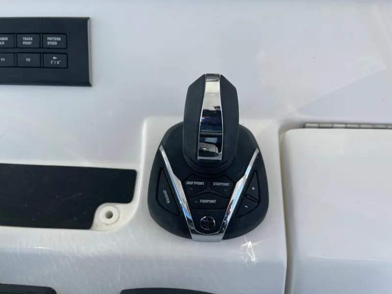 Slide: The Image of Control panel of a 2022 Regulator 28 boat with joystick and buttons. - 15