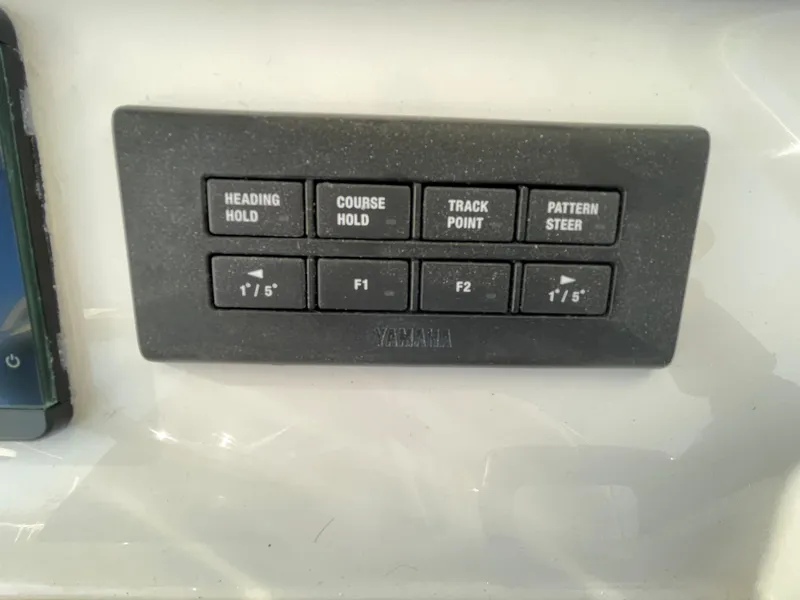 Slide: The Image of Control panel of a 2022 Regulator 28 boat with navigation buttons. - 16