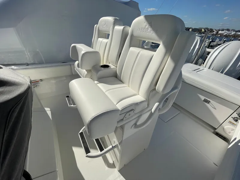 Slide: The Image of 2022 Regulator 28 boat with luxurious white seating and armrests, showcasing premium marine design. - 18