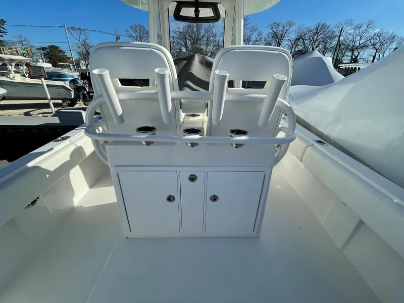 Slide: The Image of 2022 Regulator 28 boat interior with dual seats and rod holders. - 19
