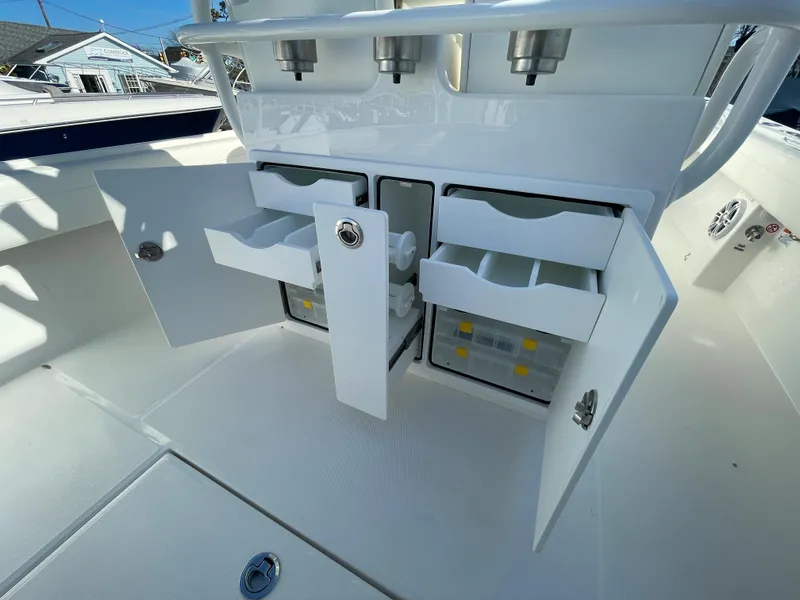 Slide: The Image of 2022 Regulator 28 boat with open storage compartments and tackle drawers. - 20