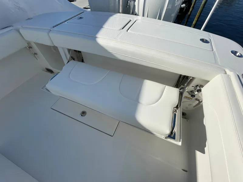 Slide: The Image of 2022 Regulator 28 boat with white cushioned seating and storage compartments. - 22