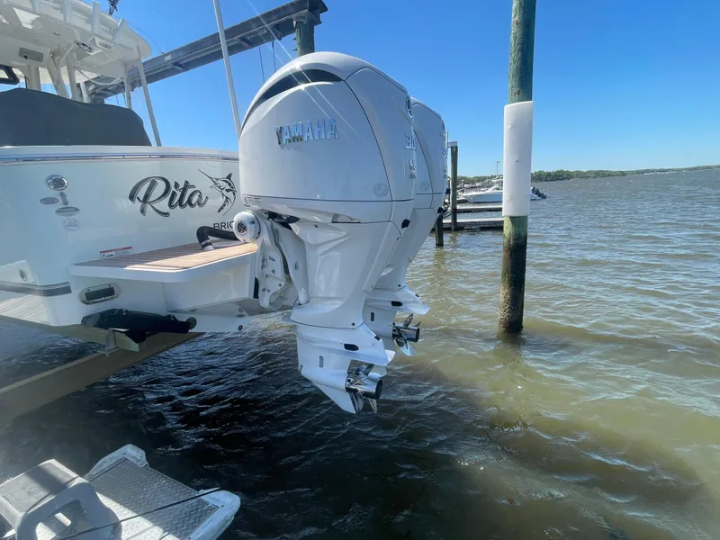 Slide: The Image of 2022 Regulator 28 boat with dual Yamaha outboard engines on a sunny day. - 25