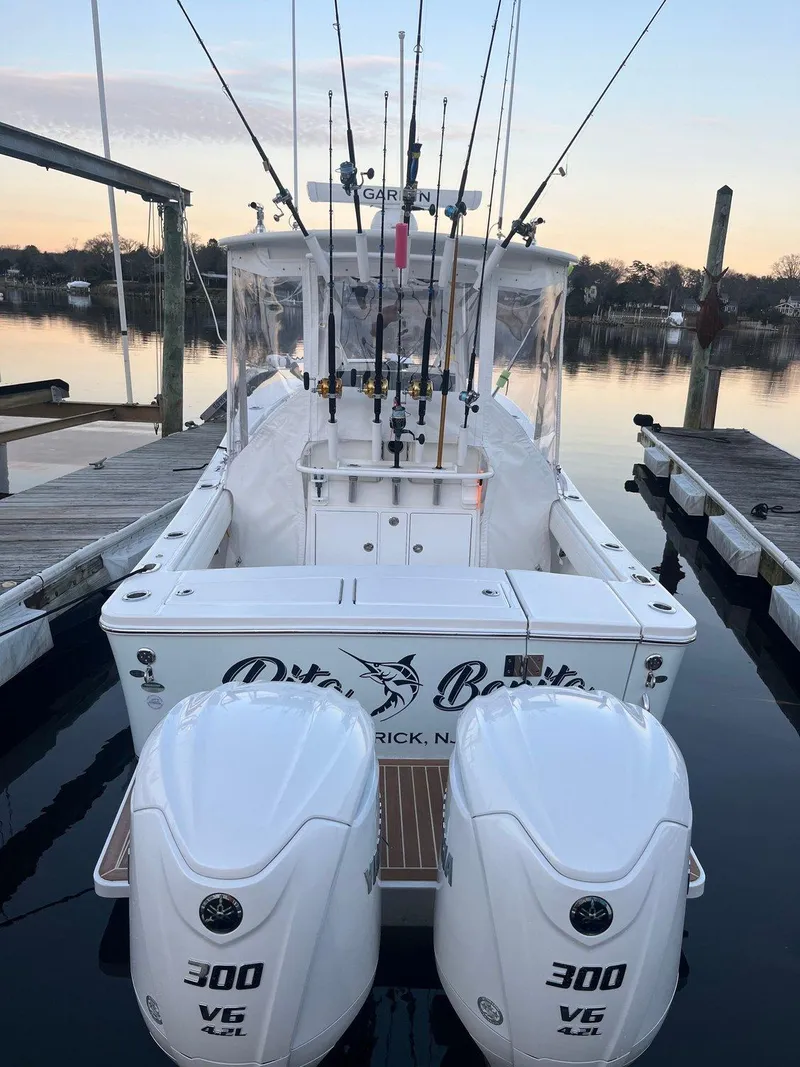 Slide: The Image of 2022 Regulator 28 boat with twin 300 V6 engines docked at sunset. - 3