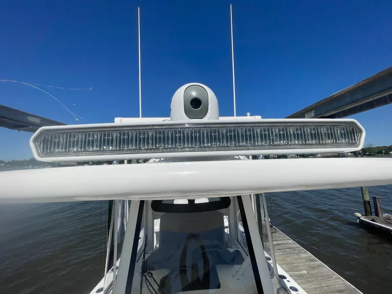 Slide: The Image of 2022 Regulator 28 boat with advanced radar system, docked under clear blue sky. - 36