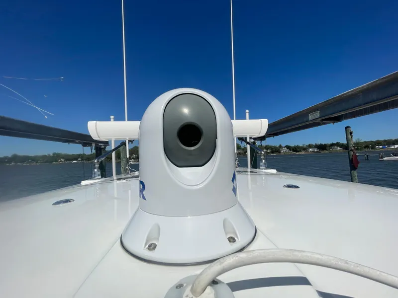Slide: The Image of 2022 Regulator 28 boat with radar equipment on deck, clear blue sky background. - 37