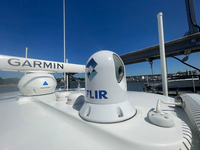 Slide: The Image of 2022 Regulator 28 boat with Garmin and FLIR equipment on deck, under clear blue sky. - 38