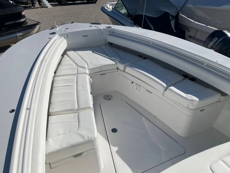 Slide: The Image of 2022 Regulator 28 boat with spacious white seating area and sleek design. - 4