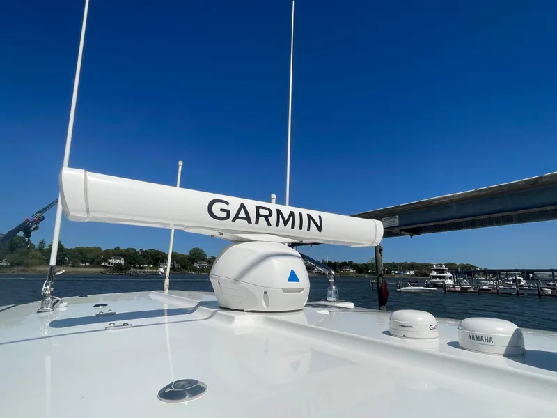 Slide: The Image of 2022 Regulator 28 boat with Garmin radar system, docked under clear blue sky. - 41