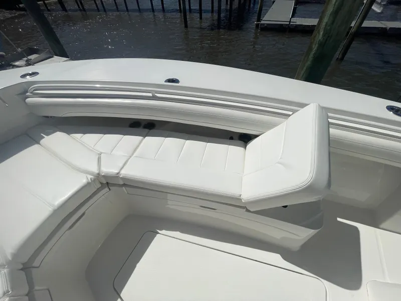 Slide: The Image of 2022 Regulator 28 boat with white cushioned seating in the bow area. - 44