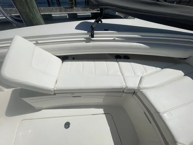 Slide: The Image of 2022 Regulator 28 boat with white cushioned seating in the bow area. - 45