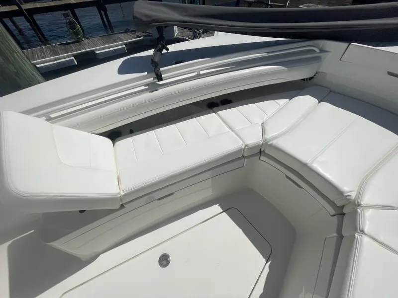 Slide: The Image of 2022 Regulator 28 boat with white cushioned seating in the bow area. - 46
