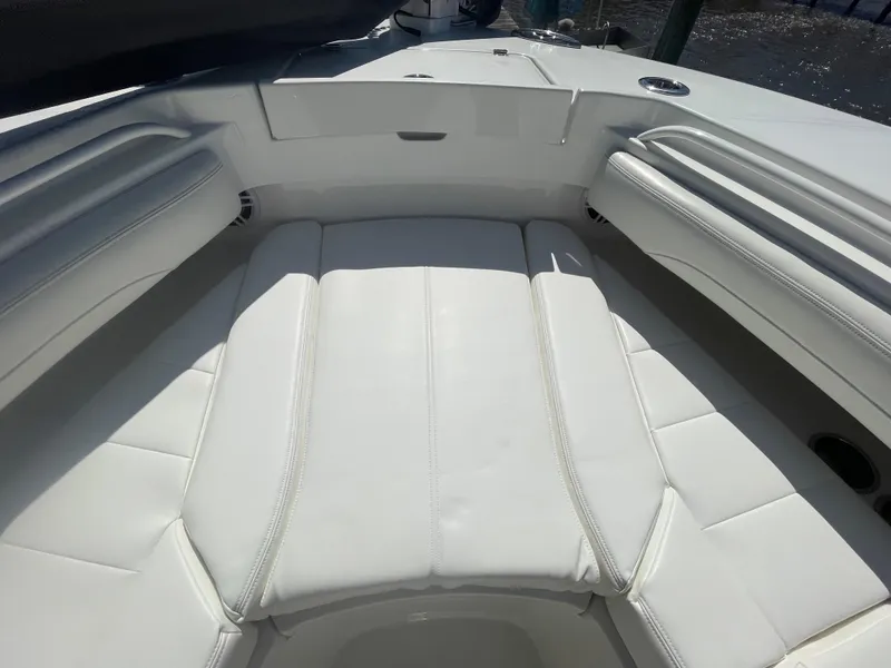 Slide: The Image of 2022 Regulator 28 boat with spacious white cushioned seating area. - 48