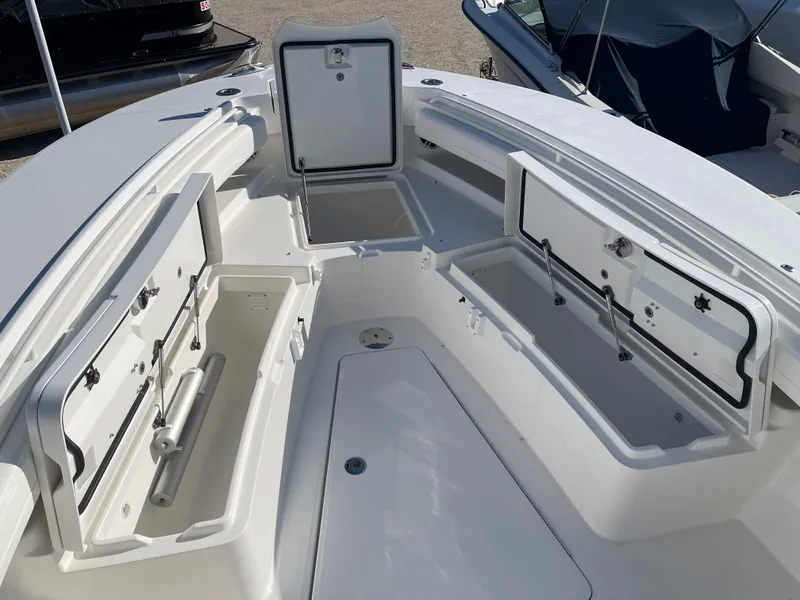 Slide: The Image of 2022 Regulator 28 boat with open storage compartments on deck. - 7