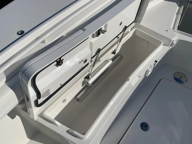 Slide: The Image of 2022 Regulator 28 boat storage compartment with open lid, showcasing spacious interior design. - 8