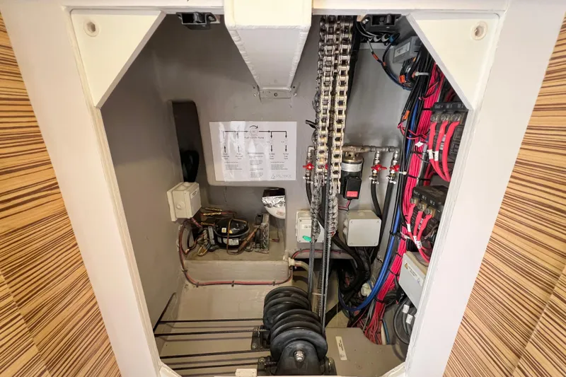 Slide: The Image of Blue Victron Energy device, model Titan 48/501, mounted on a wall with cables. - 100