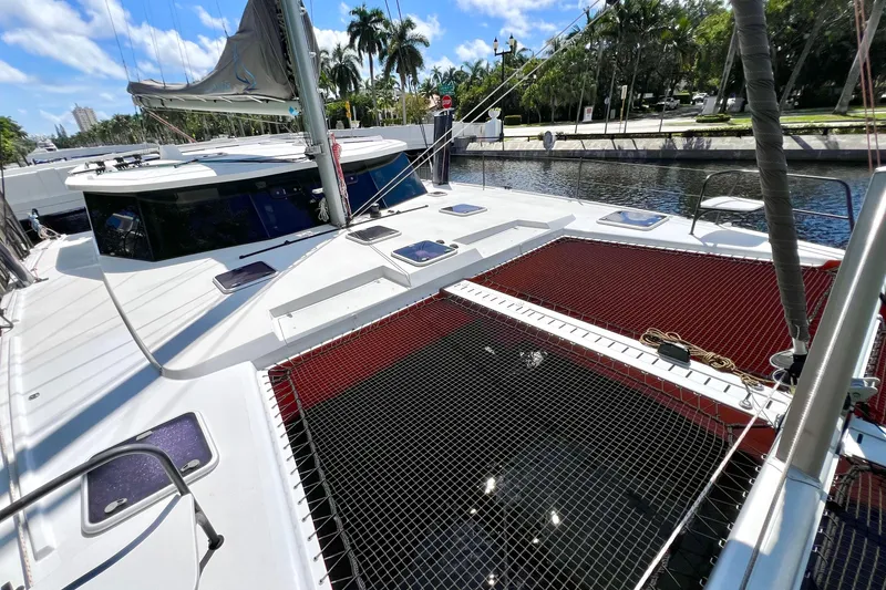 Slide: The Image of Orange Balance 482 catamaran docked in a marina, 2021 model. - 13