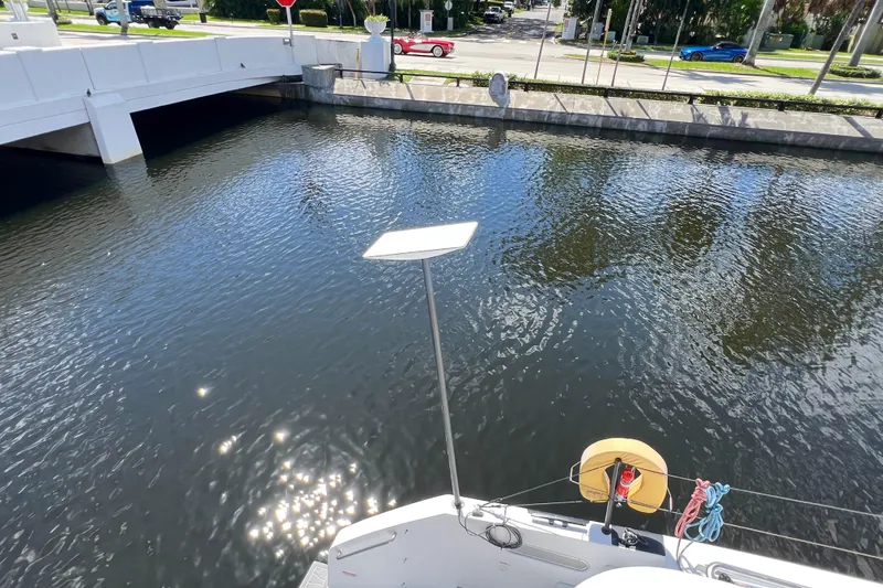 Slide: The Image of Sailboat mast and boom with sail cover, Balance 482, 2021 model, under clear blue sky. - 133