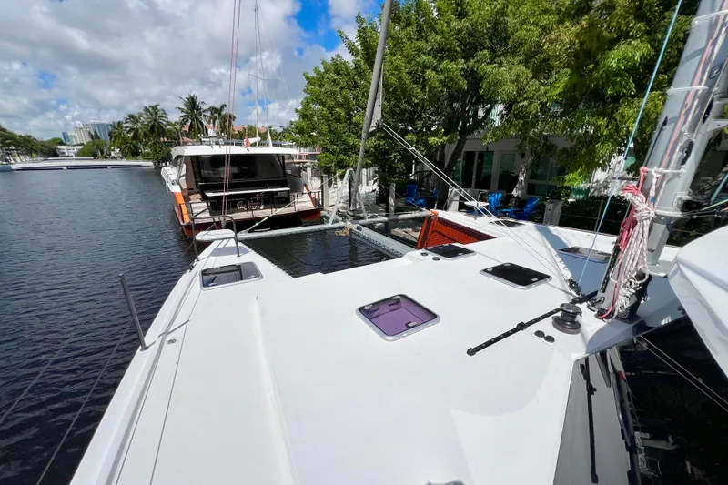 Slide: The Image of Catamaran docked in a canal, surrounded by palm trees, Balance 482 model, 2021. - 15
