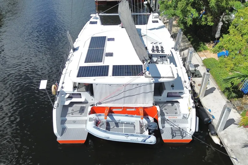 Slide: The Image of Aerial view of 2021 Balance 482 catamaran with solar panels and docked dinghy. - 156