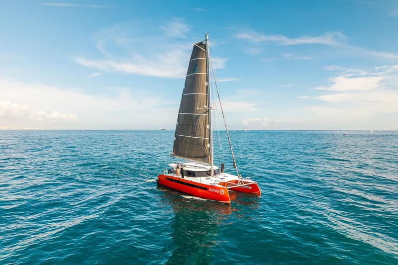 Slide: The Image of Red Balance 482 catamaran sailing on open sea under clear blue sky, 2021 model. - 167