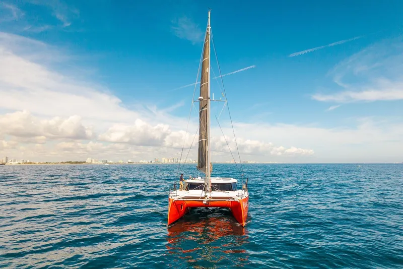 Slide: The Image of Red Balance 482 catamaran sailing on open sea under clear blue sky, 2021 model. - 169