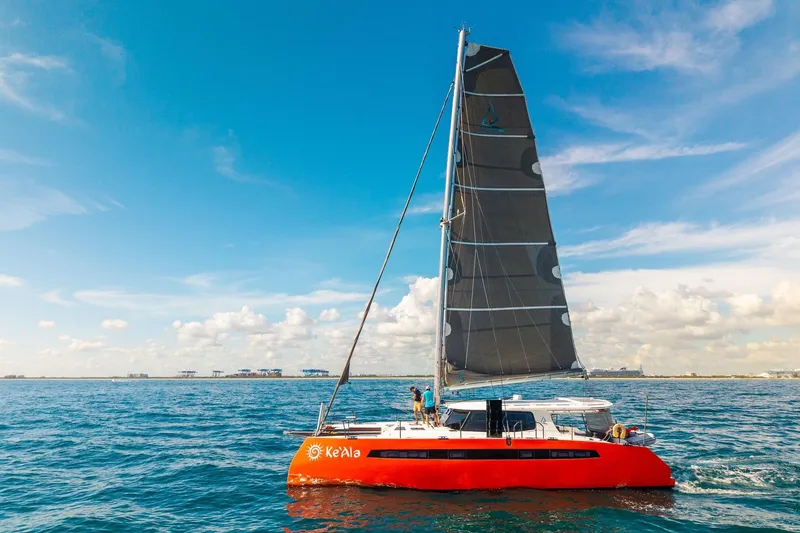 Slide: The Image of Red Balance 482 catamaran sailing on open sea under clear blue sky, 2021 model. - 170