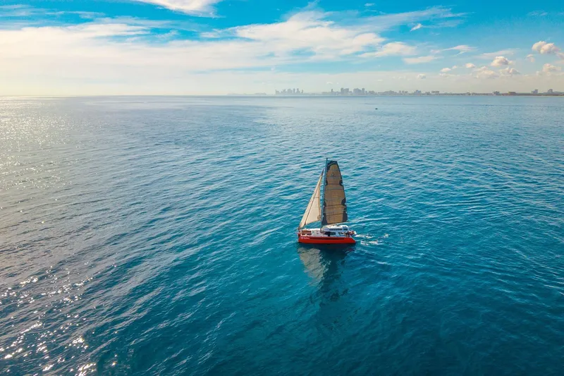 Slide: The Image of Sailboat Balance 482 on open sea with city skyline in background, 2021 model. - 171