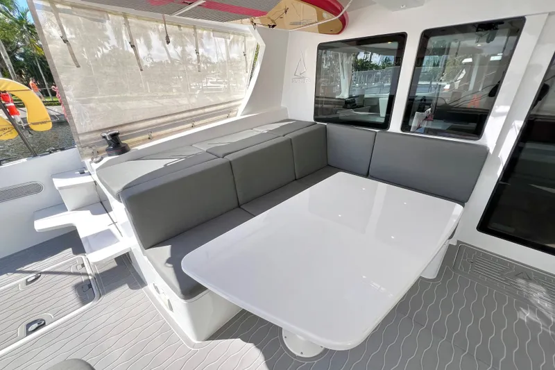 Slide: The Image of Catamaran Balance 482 cruising near marina, city skyline in background, sunny day, 2021 model. - 26