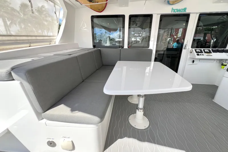 Slide: The Image of Luxurious 2021 Balance 482 yacht interior with seating, surfboards, and scenic marina view. - 27