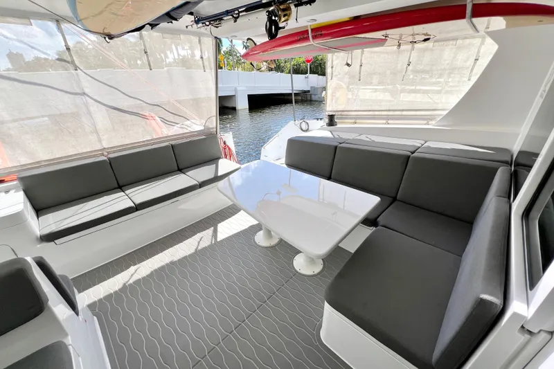 Slide: The Image of Interior view of 2021 Balance 482 yacht with seating, table, and water view. - 28