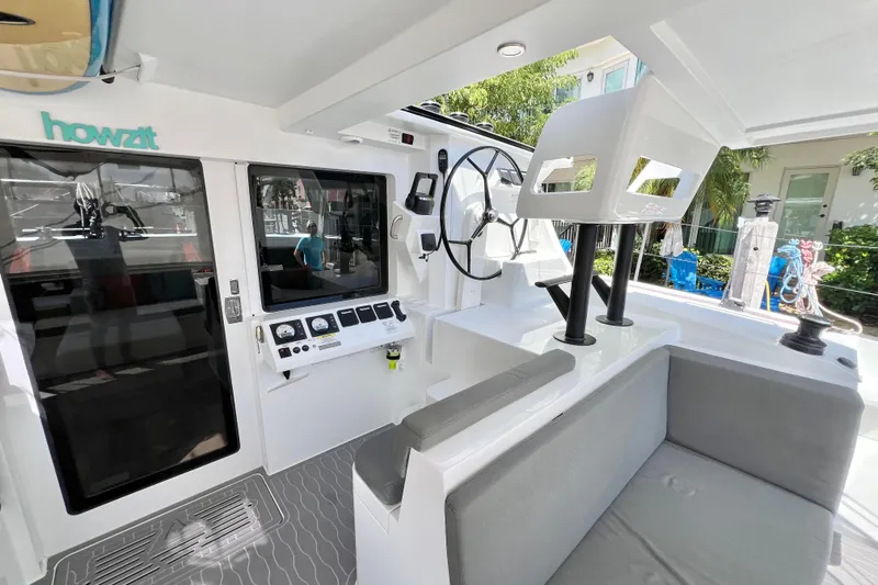 Slide: The Image of Luxurious 2021 Balance 482 catamaran interior with surfboards, seating, and dining area. - 29