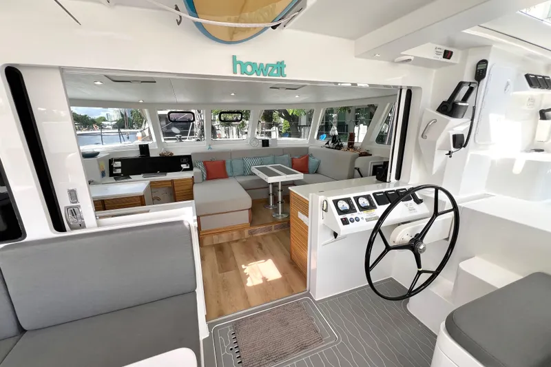 Slide: The Image of Interior of 2021 Balance 482 catamaran with steering wheel and seating area. - 34